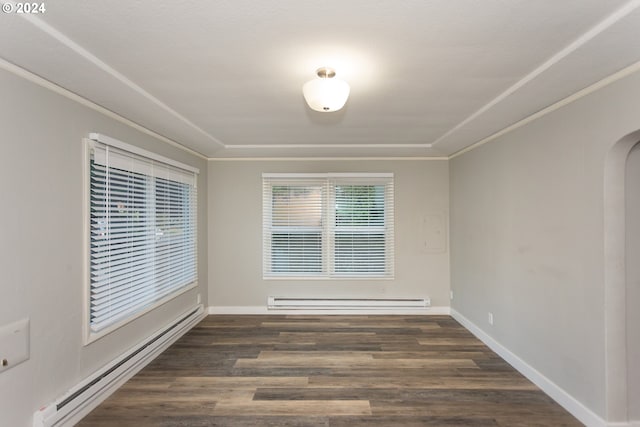 unfurnished room with a baseboard heating unit, ornamental molding, arched walkways, and dark wood finished floors