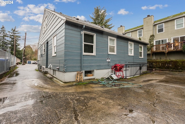 rear view of property with fence and a chimney