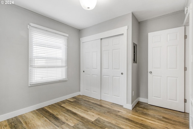 unfurnished bedroom featuring hardwood / wood-style floors and a closet