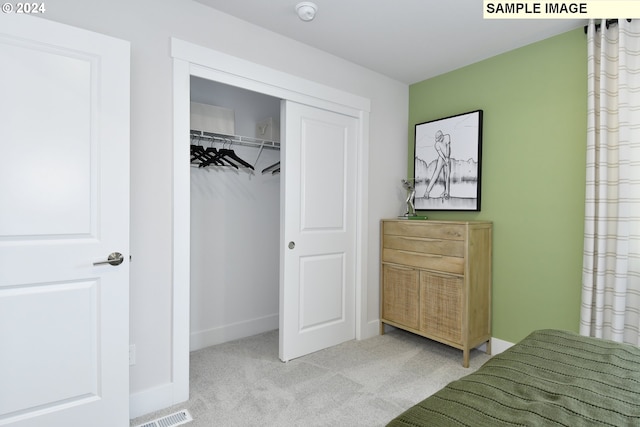 carpeted bedroom featuring a closet