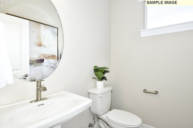 bathroom with toilet and sink