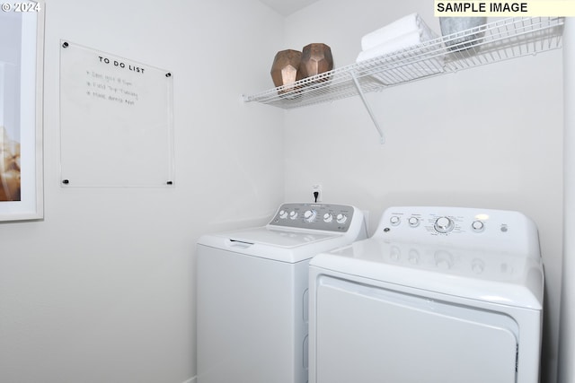 clothes washing area featuring separate washer and dryer