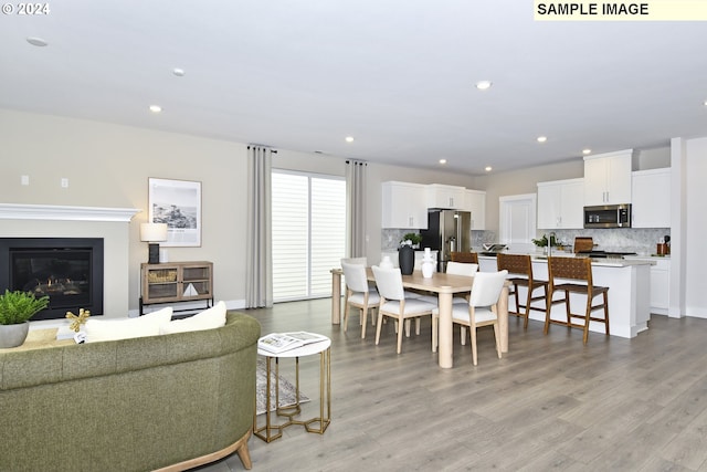 dining space with light hardwood / wood-style flooring