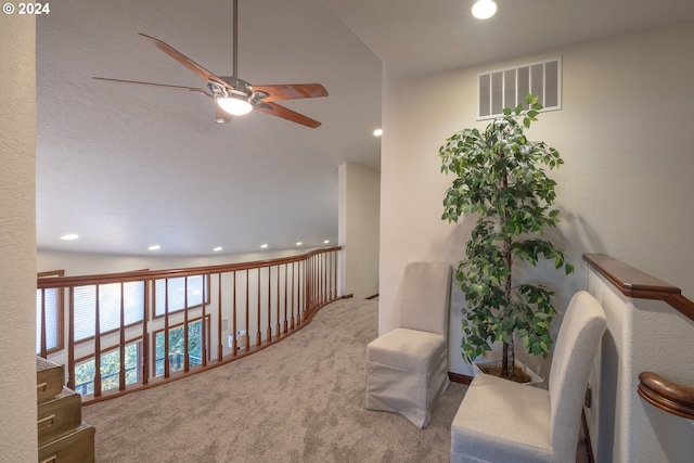 sitting room featuring vaulted ceiling, carpet, and ceiling fan