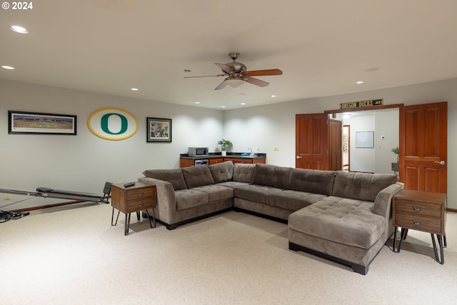 living room with ceiling fan and light colored carpet