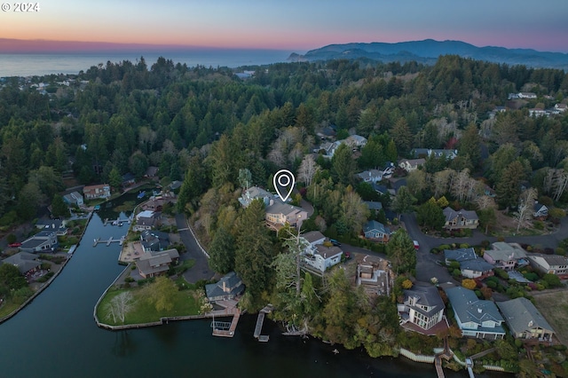 aerial view at dusk with a water view