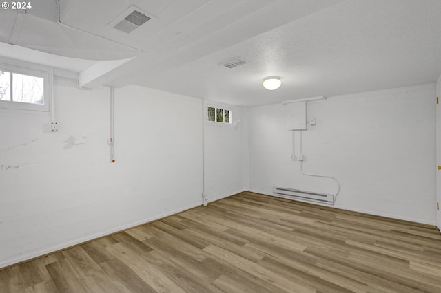 1212 Laurel St Unit 9, Lake Oswego, OR 97034 - basement with a baseboard heating unit, wood finished floors, and healthy amount of natural light