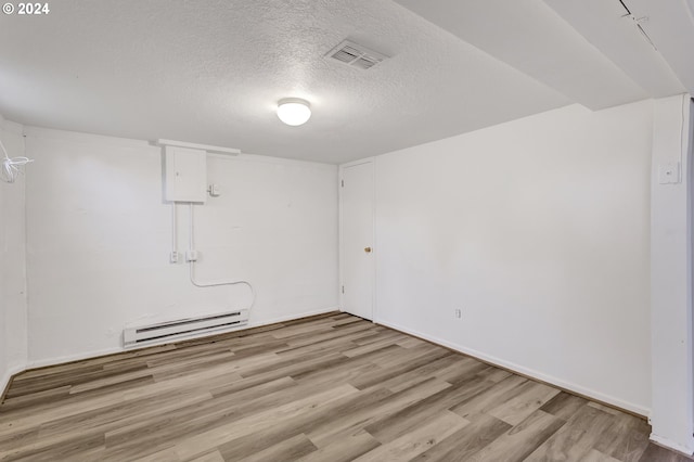 1212 Laurel St Unit 9, Lake Oswego, OR 97034 - spare room with a baseboard heating unit, light wood-type flooring, a textured ceiling, and baseboards