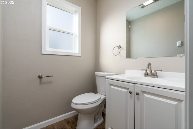 bathroom with vanity, hardwood / wood-style floors, and toilet