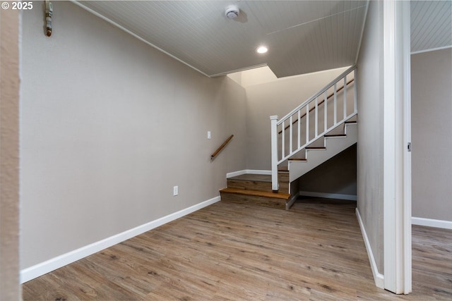 staircase featuring wood-type flooring