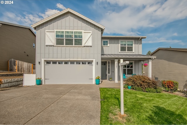 view of front of home featuring a garage and a front lawn