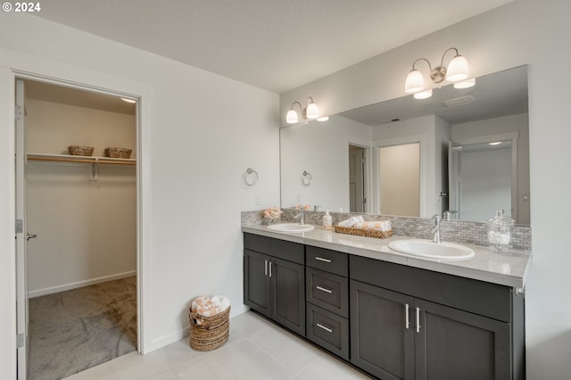 bathroom with vanity, decorative backsplash, and tile patterned floors