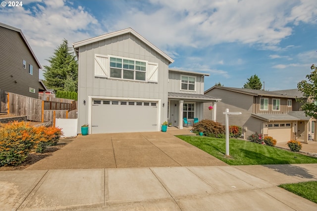 view of front facade with a garage and a front lawn