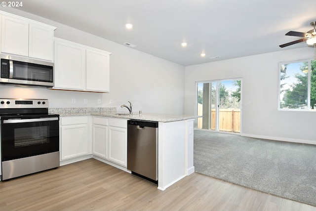 kitchen with light hardwood / wood-style floors, sink, white cabinetry, and stainless steel appliances