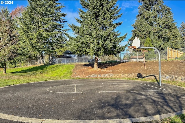 view of basketball court featuring a yard