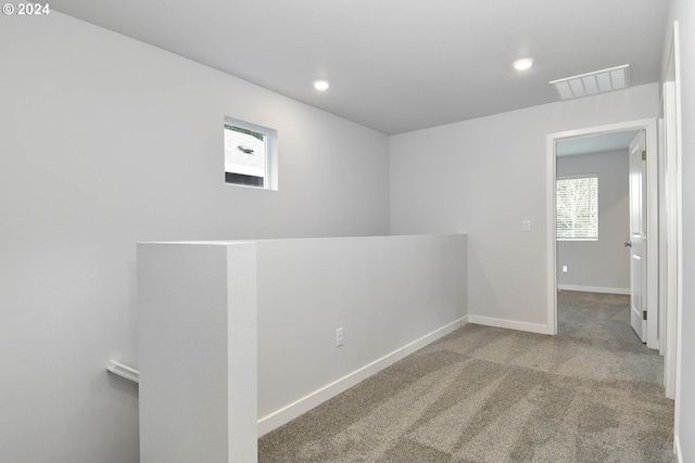 unfurnished room featuring light colored carpet