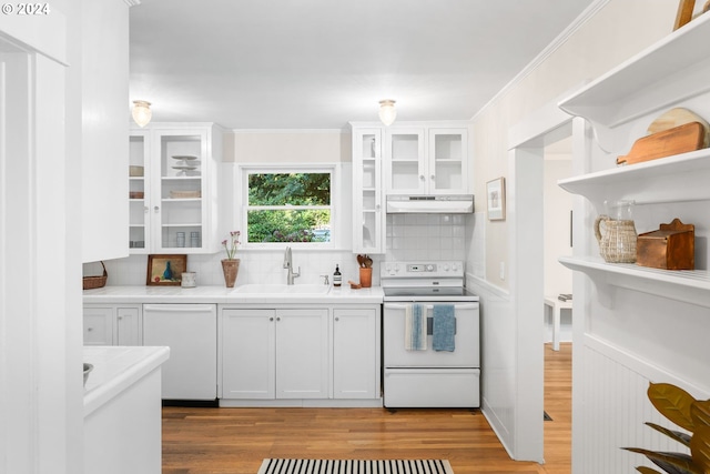 kitchen with white dishwasher, range with electric stovetop, sink, decorative backsplash, and white cabinets