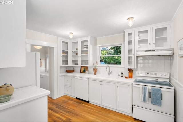 kitchen with electric range oven, sink, white dishwasher, decorative backsplash, and white cabinets