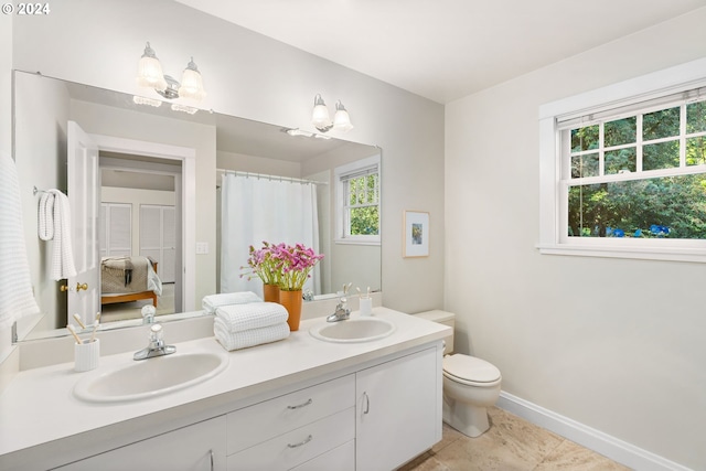 bathroom with vanity, toilet, and tile patterned floors