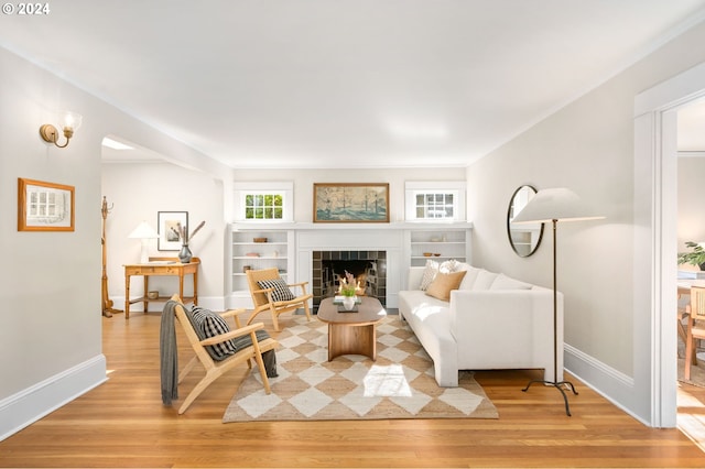 living room with light hardwood / wood-style flooring and a tile fireplace