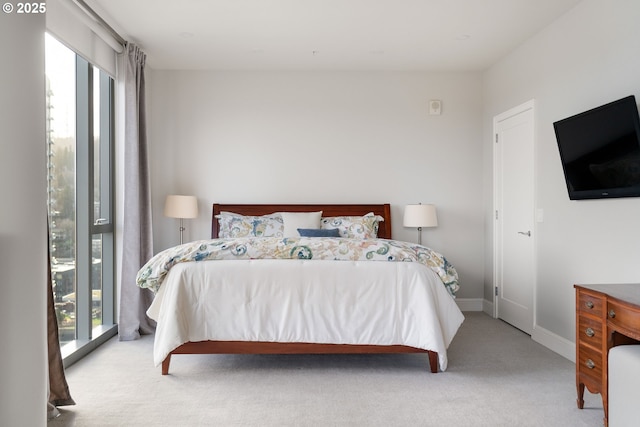 carpeted bedroom with baseboards