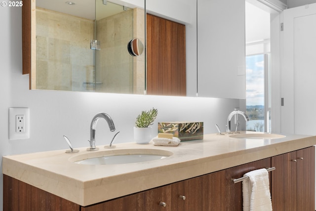 bathroom with walk in shower, a sink, and double vanity