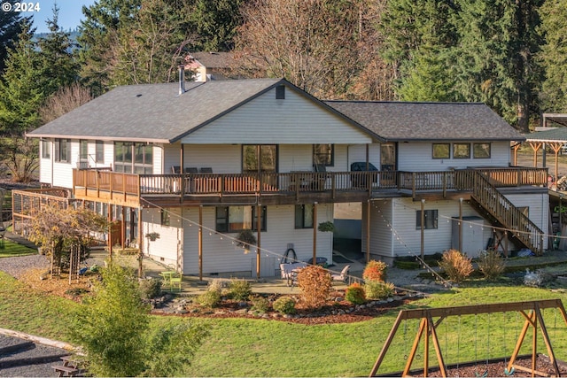 rear view of house with a yard and a deck