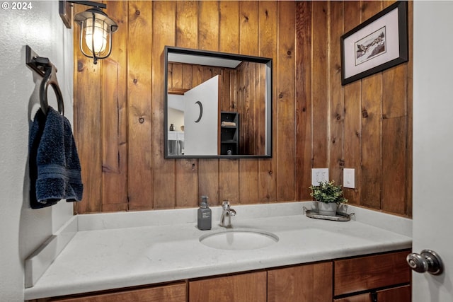 bathroom with vanity and wooden walls