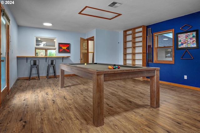 playroom featuring bar, hardwood / wood-style floors, and pool table