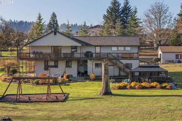 back of property with a lawn and a deck