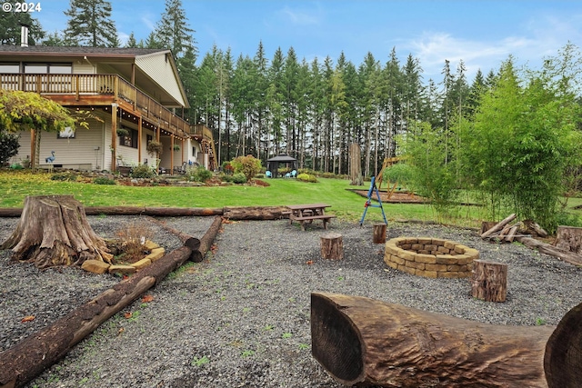 view of yard with a fire pit and a wooden deck