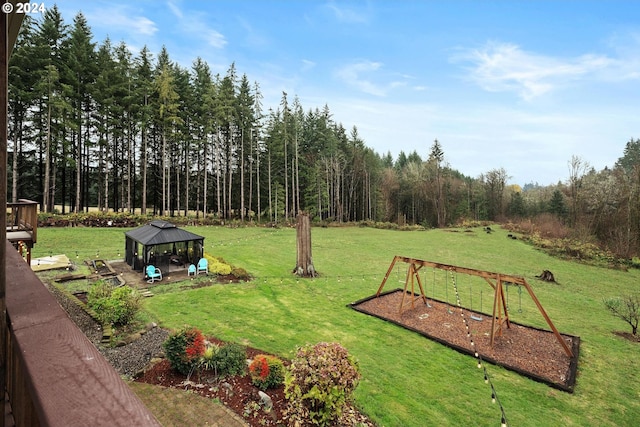 view of yard featuring a gazebo and a playground