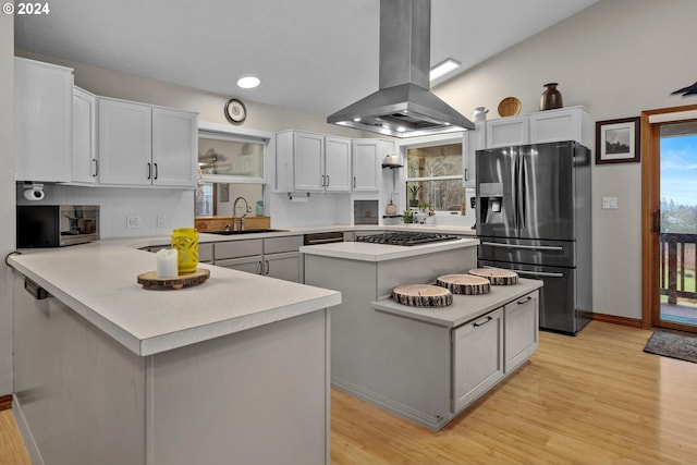 kitchen with a center island, white cabinets, sink, appliances with stainless steel finishes, and island range hood