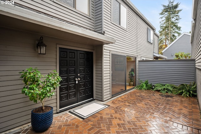 view of exterior entry featuring a patio area