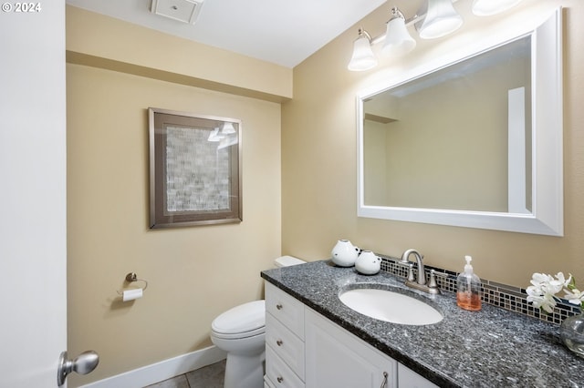 bathroom with vanity, toilet, and tile patterned floors