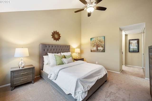 bedroom featuring light carpet, high vaulted ceiling, and ceiling fan