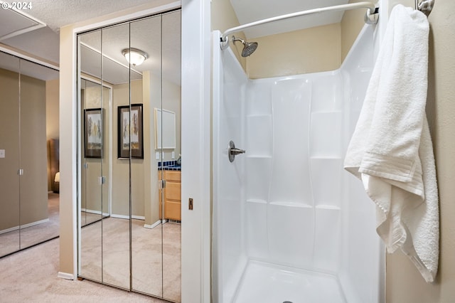 bathroom with a shower and a textured ceiling