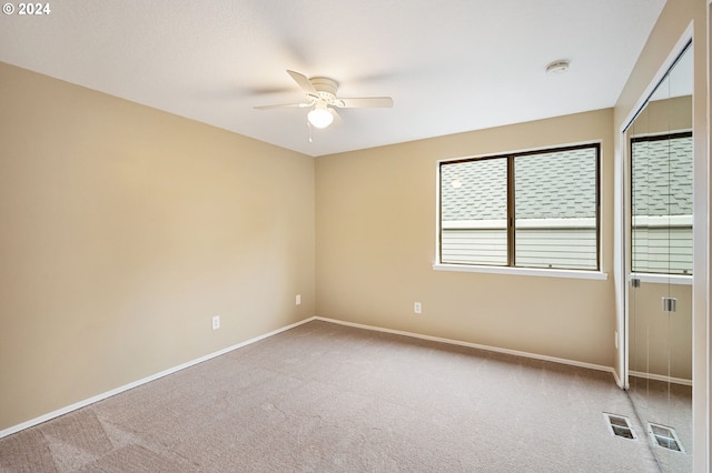 carpeted empty room with ceiling fan