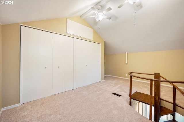 additional living space featuring light carpet, vaulted ceiling with beams, and ceiling fan