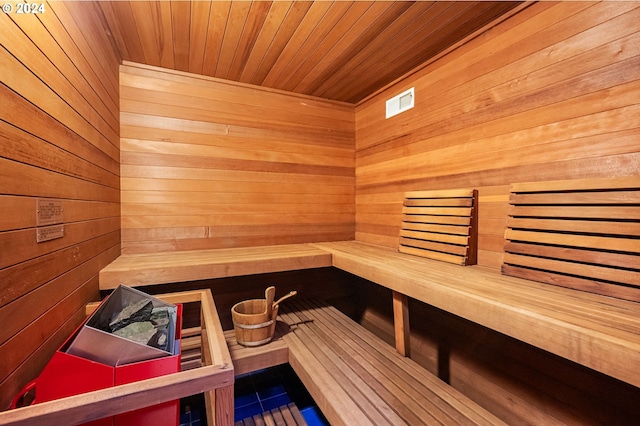 view of sauna / steam room with wood ceiling and wooden walls