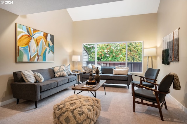 carpeted living room featuring high vaulted ceiling