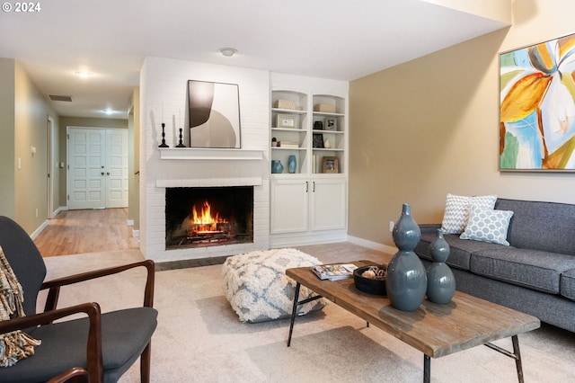 living room with light hardwood / wood-style flooring and a fireplace