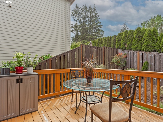 wooden deck featuring outdoor dining area