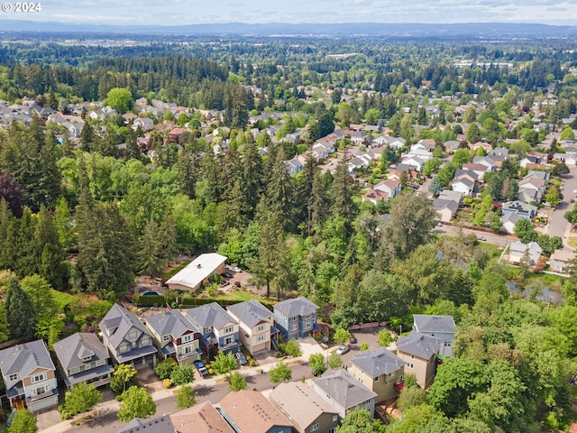 drone / aerial view with a forest view and a residential view