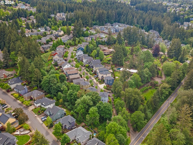 drone / aerial view with a residential view and a view of trees
