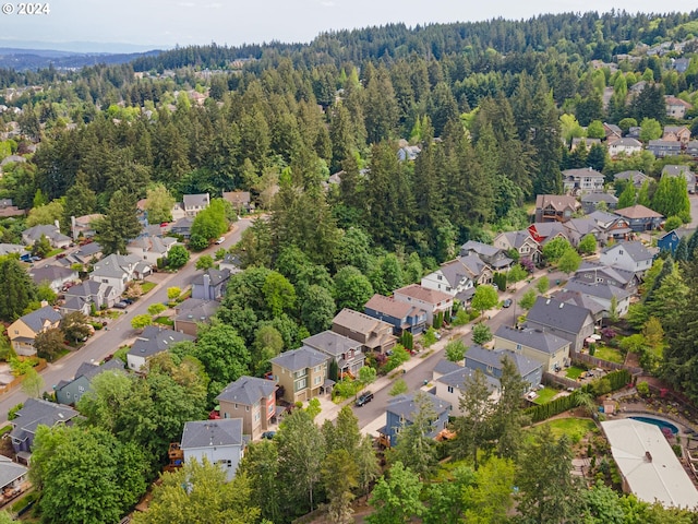 aerial view with a wooded view and a residential view