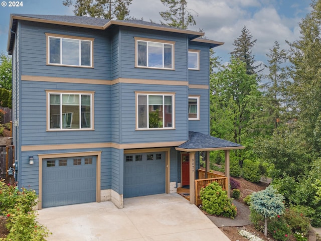view of front of home with concrete driveway and an attached garage