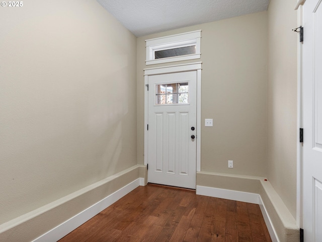 interior space with baseboards and dark wood-style floors