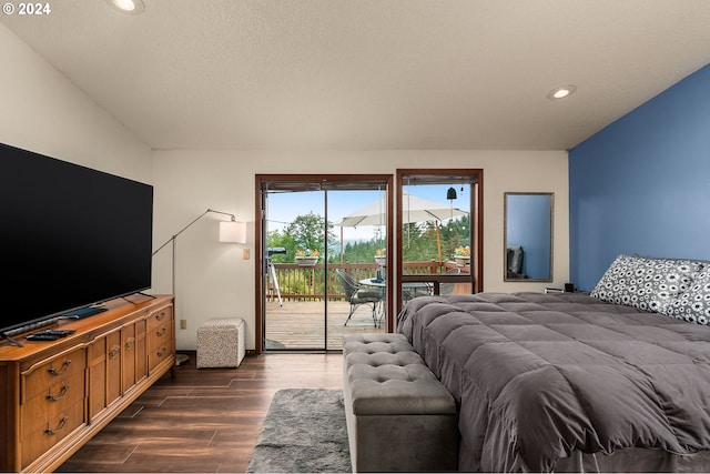 bedroom with access to exterior and dark wood-type flooring