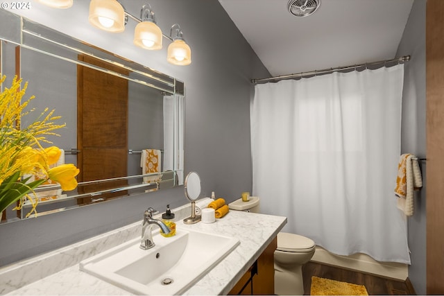 bathroom featuring wood-type flooring, vanity, and toilet